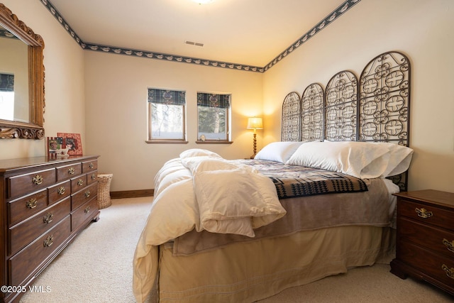 bedroom with visible vents, baseboards, and carpet