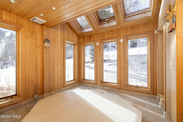 unfurnished sunroom with wood ceiling and a skylight