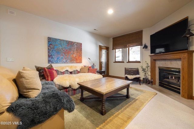 living room featuring visible vents and a premium fireplace