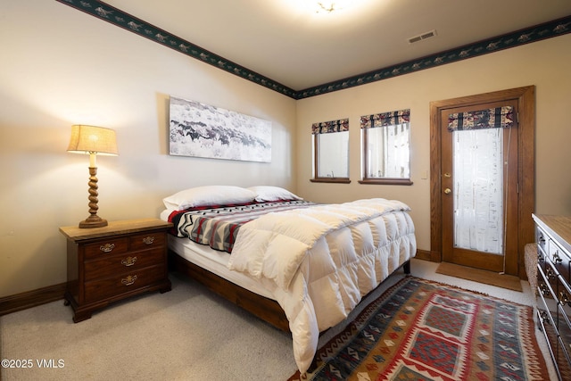 bedroom featuring light carpet, visible vents, and baseboards