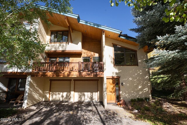 view of front facade with a balcony and a garage