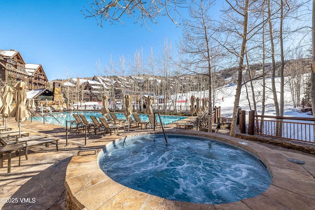 community pool featuring a hot tub