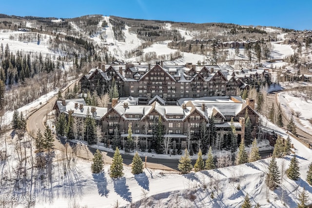 snowy aerial view with a mountain view