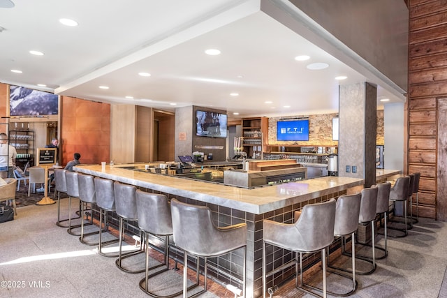 bar with wet bar and recessed lighting