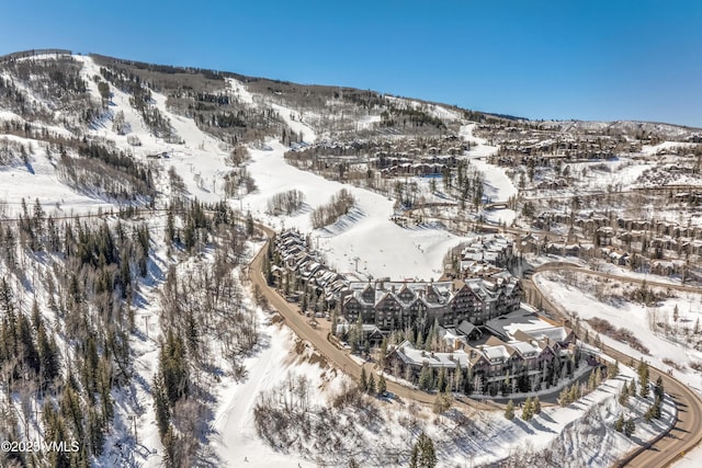 snowy aerial view featuring a mountain view