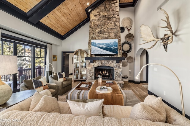 living room with wood finished floors, high vaulted ceiling, a fireplace, wood ceiling, and beamed ceiling