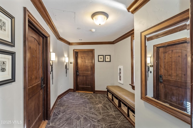 foyer featuring baseboards and ornamental molding