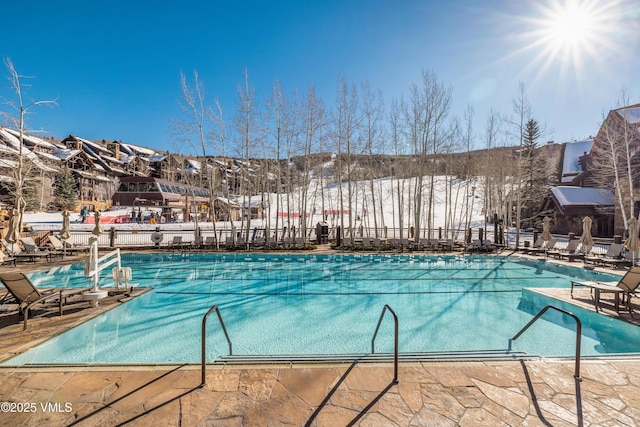 community pool featuring a patio area and fence