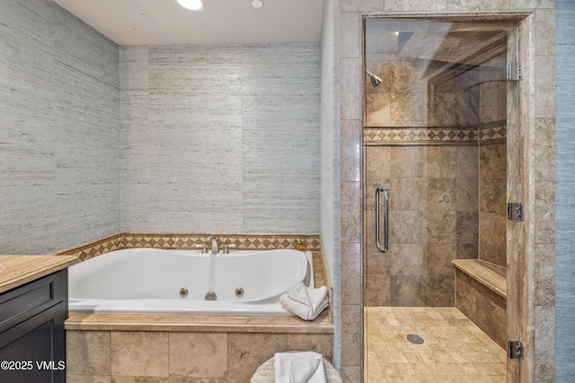 bathroom with a whirlpool tub, a shower stall, and vanity