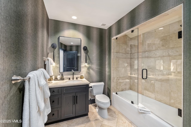 bathroom with enclosed tub / shower combo, visible vents, toilet, and vanity