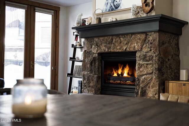 room details featuring a fireplace and french doors