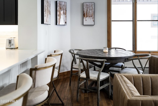 dining room with dark wood-type flooring