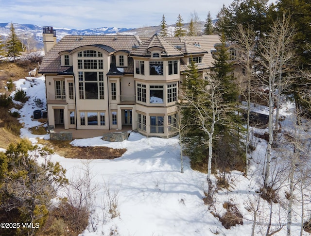460 El Mirador Rd, Edwards, CO 81632 - snow covered rear of property featuring a chimney and stucco siding