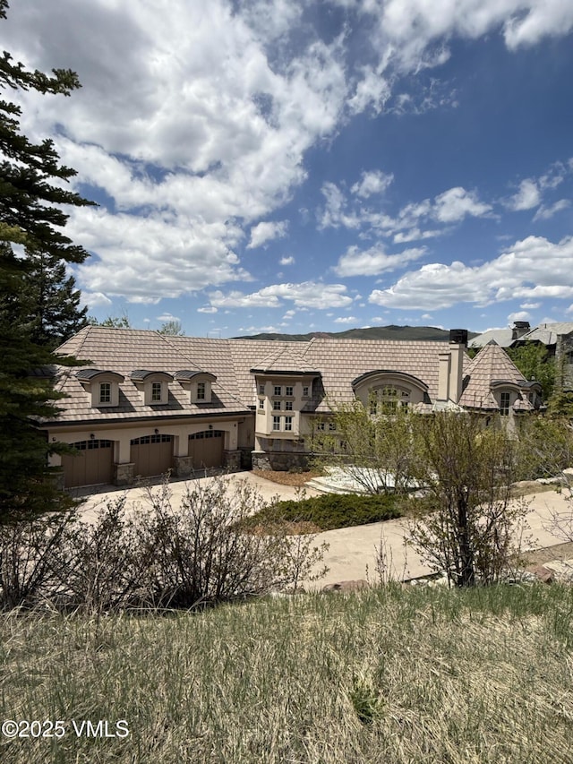 460 El Mirador Rd, Edwards, CO 81632 - french country home with stone siding, stucco siding, a garage, and driveway