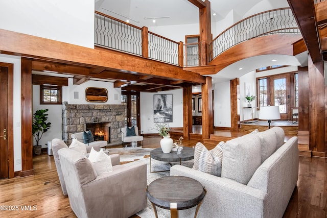 460 El Mirador Rd, Edwards, CO 81632 - living room with a towering ceiling, wood finished floors, a stone fireplace, and baseboards