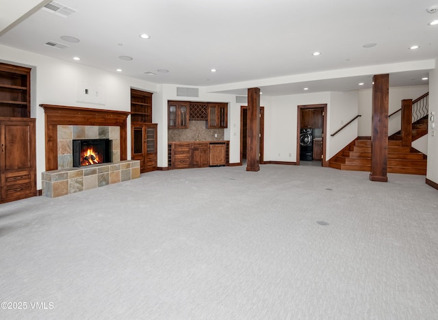 460 El Mirador Rd, Edwards, CO 81632 - unfurnished living room featuring stairway, recessed lighting, light carpet, a tile fireplace, and bar area