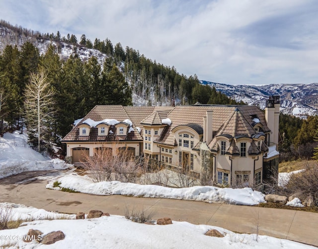 460 El Mirador Rd, Edwards, CO 81632 - snow covered house featuring a chimney and stucco siding