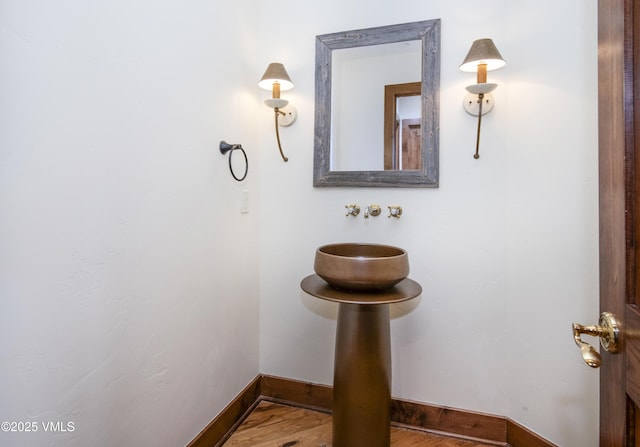 460 El Mirador Rd, Edwards, CO 81632 - bathroom featuring a sink, baseboards, and wood finished floors