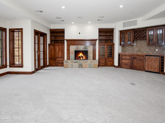 460 El Mirador Rd, Edwards, CO 81632 - unfurnished living room with wet bar, a tile fireplace, recessed lighting, baseboards, and light carpet