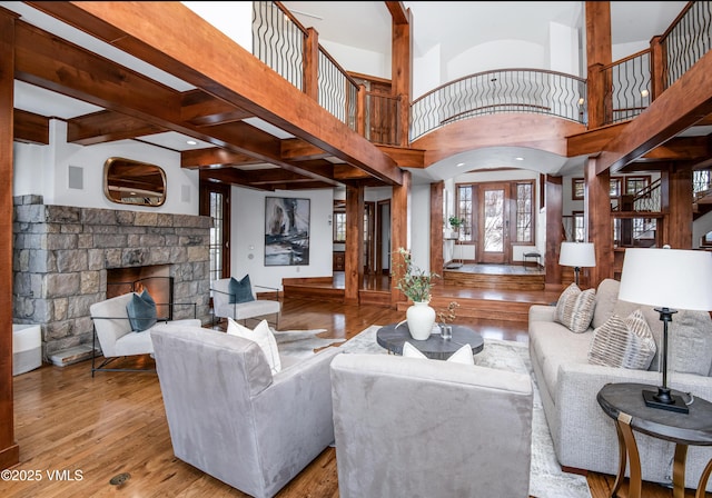 460 El Mirador Rd, Edwards, CO 81632 - living area featuring wood finished floors, a stone fireplace, stairs, and a high ceiling