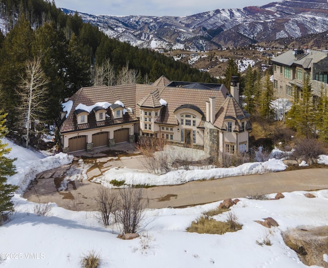 460 El Mirador Rd, Edwards, CO 81632 - view of front of property with a garage, a chimney, driveway, and a mountain view