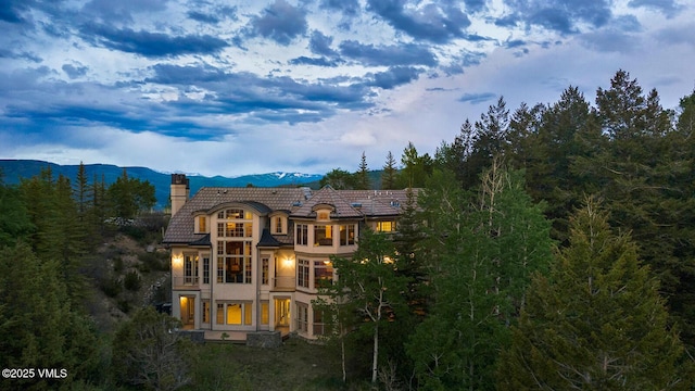 460 El Mirador Rd, Edwards, CO 81632 - back of property featuring a chimney, a tiled roof, stucco siding, a mountain view, and a balcony