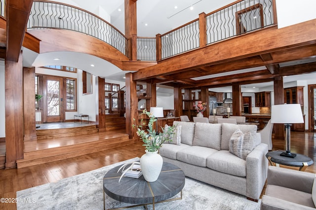 460 El Mirador Rd, Edwards, CO 81632 - living area featuring hardwood / wood-style floors, beam ceiling, stairs, and decorative columns