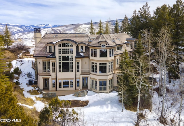 460 El Mirador Rd, Edwards, CO 81632 - snow covered rear of property with a chimney, stucco siding, and a mountain view