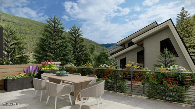 view of patio / terrace featuring outdoor dining space and a mountain view