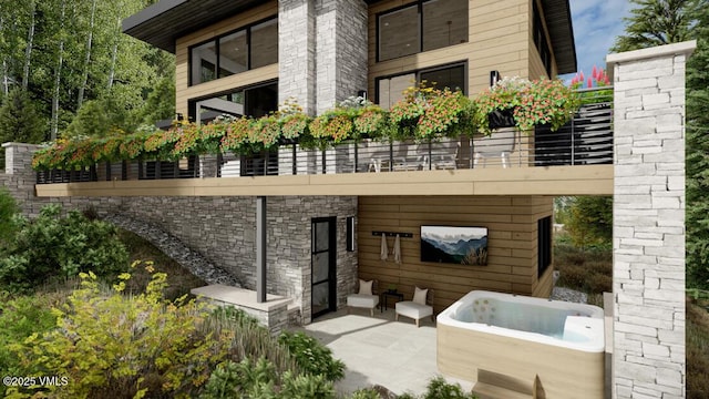 rear view of house with stone siding and a patio area