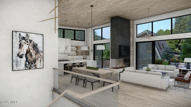 dining area featuring a high ceiling, plenty of natural light, and wood finished floors