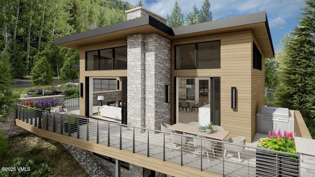 back of house featuring outdoor dining space, stone siding, and a patio