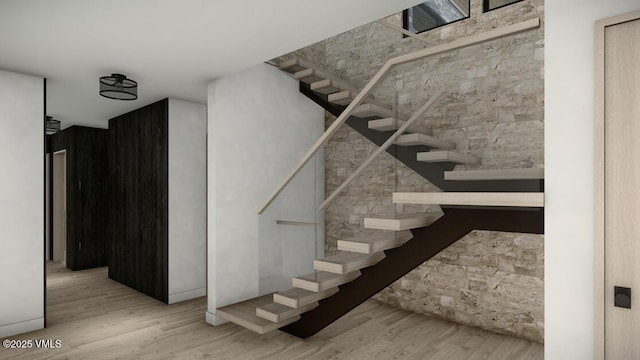 stairway featuring wood finished floors