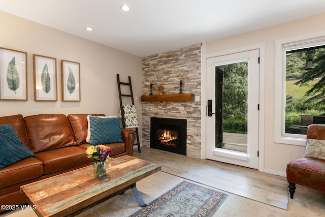 4610 Vail Racquet Club Dr Unit 2, Vail, CO 81657 - living area featuring a stone fireplace, light wood-type flooring, and recessed lighting