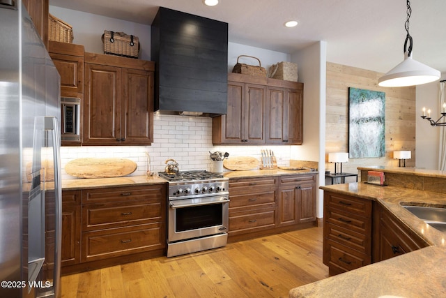 751 Singletree Rd Unit 28, Edwards, CO 81632 - kitchen featuring stainless steel appliances, extractor fan, light stone countertops, backsplash, and recessed lighting