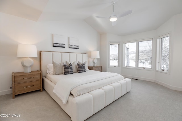 bedroom featuring vaulted ceiling, light carpet, and ceiling fan