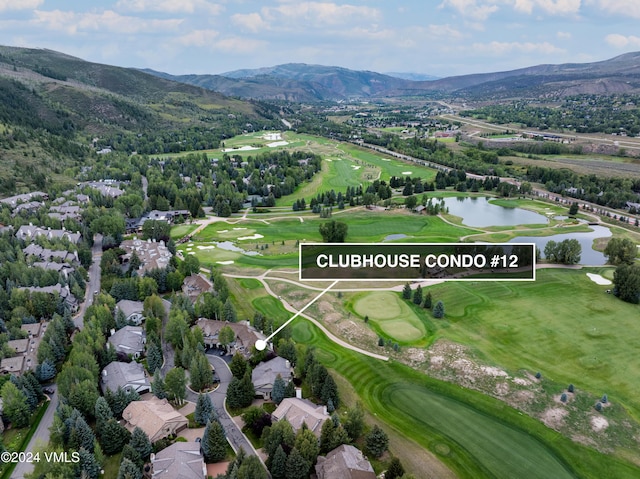 birds eye view of property with a water and mountain view