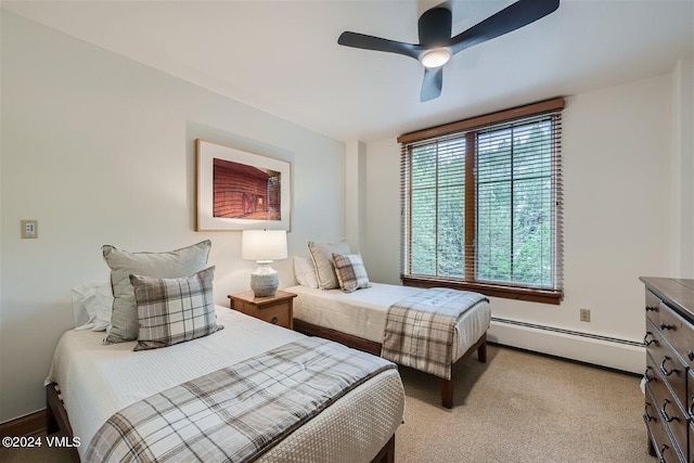 bedroom featuring a baseboard radiator, light carpet, and ceiling fan