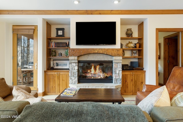 living room with a stone fireplace and built in features