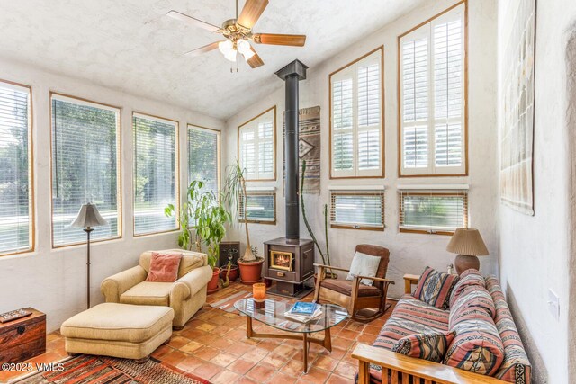 20 Hereford Rd, Edwards, CO 81632 - sunroom / solarium with a wood stove, vaulted ceiling, tile patterned floors, and a textured wall