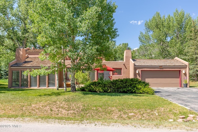 20 Hereford Rd, Edwards, CO 81632 - view of front of home with driveway, a garage, a chimney, and a front lawn