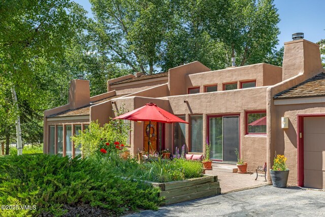 20 Hereford Rd, Edwards, CO 81632 - rear view of house featuring a chimney and stucco siding