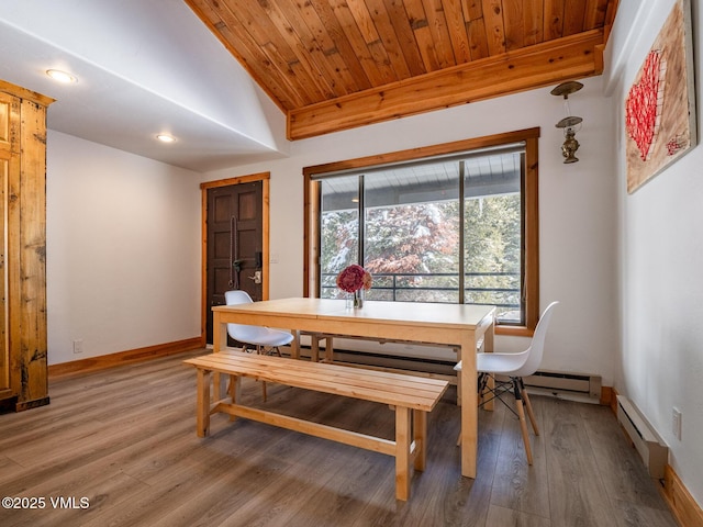 dining area with wooden ceiling, a baseboard heating unit, baseboards, vaulted ceiling, and light wood-style floors