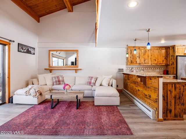 living room with beamed ceiling, light wood finished floors, baseboard heating, and high vaulted ceiling