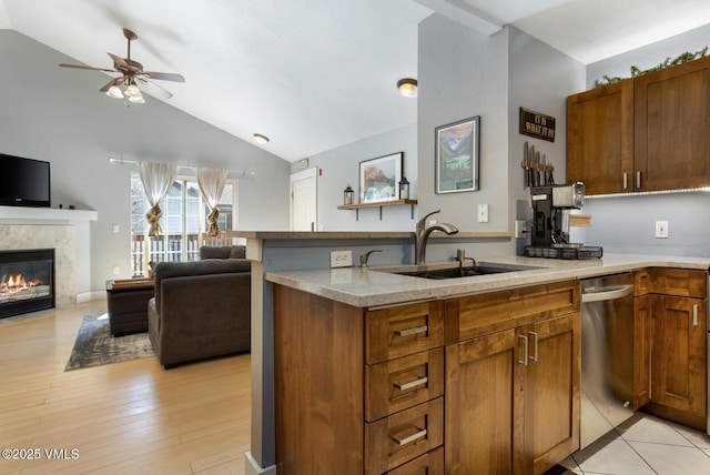 1303 Crazy Horse Cir Unit 1303, Edwards, CO 81632 - kitchen with stainless steel dishwasher, ceiling fan, a sink, vaulted ceiling, and a peninsula
