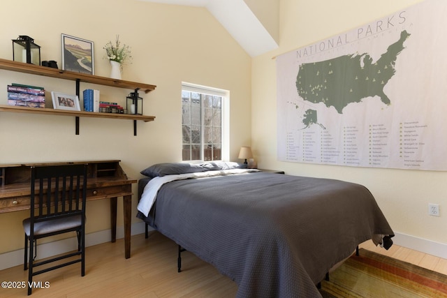 1303 Crazy Horse Cir Unit 1303, Edwards, CO 81632 - bedroom with wood finished floors, baseboards, and lofted ceiling