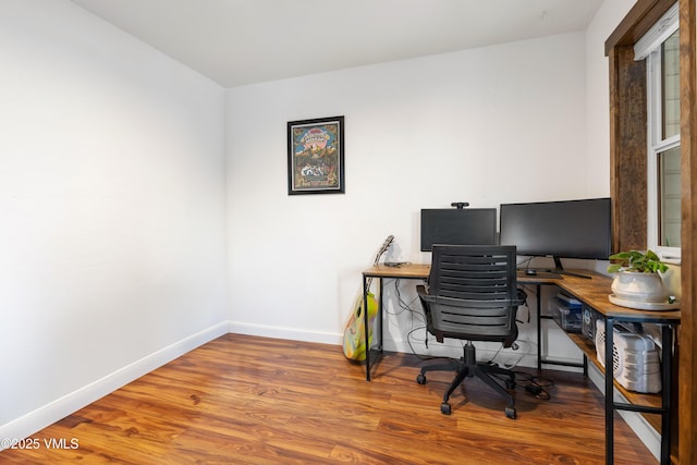 office area with baseboards and wood finished floors