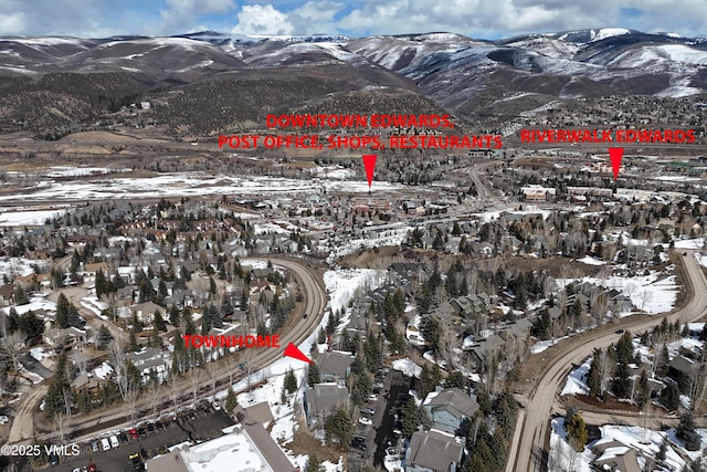 snowy aerial view featuring a mountain view