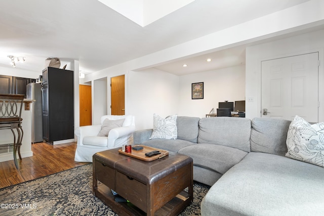 living area with wood finished floors and recessed lighting