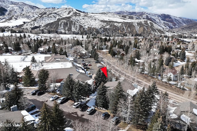 snowy aerial view featuring a mountain view